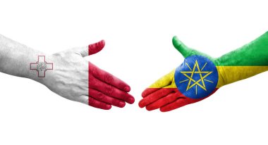 Ellere boyanmış Malta ve Etiyopya bayrakları arasındaki el sıkışma, izole şeffaf görüntü.