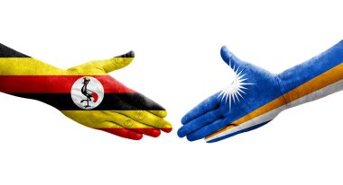 Marshall Adaları ve Uganda bayrakları arasındaki el sıkışma ellerinde izole şeffaf görüntü.