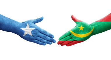 Moritanya ve Somali bayrakları arasındaki el sıkışma ellerinde resmedilmiş şeffaf görüntü.