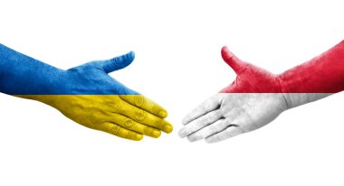 Ellerinde Monako ve Ukrayna bayrakları arasında el sıkışma, izole şeffaf görüntü.