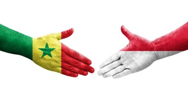 Ellerinde Monako ve Senegal bayrakları arasında el sıkışma, izole şeffaf görüntü.