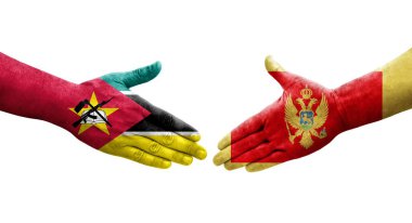 Karadağ ile Mozambik bayrakları arasındaki el sıkışma, izole edilmiş şeffaf görüntü.