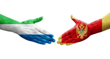 Karadağ ile Sierra Leone bayrakları arasındaki tokalaşma elleri boyanmış, şeffaf görüntü izole edilmiş.