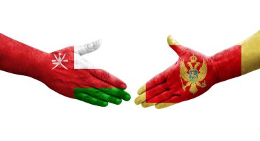 Karadağ ile Umman bayrakları arasındaki tokalaşma elleri boyalı, izole şeffaf görüntü.