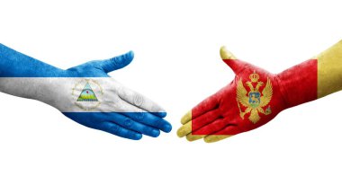 Karadağ ile Nikaragua bayrakları arasındaki tokalaşma elleri boyalı, izole şeffaf görüntü.