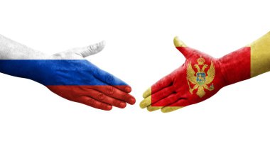 Karadağ ile Rusya arasındaki el sıkışma ellerinde bayraklar, izole edilmiş şeffaf görüntü.