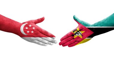 Ellerinde Mozambik ve Singapur bayrakları arasında el sıkışma, izole şeffaf görüntü.