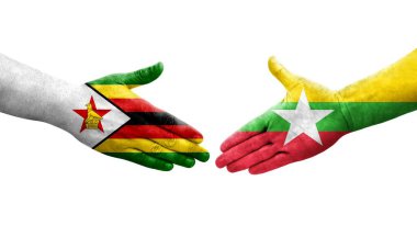 Myanmar ve Zimbabwe bayrakları arasındaki el sıkışma ellerinde izole şeffaf görüntü.