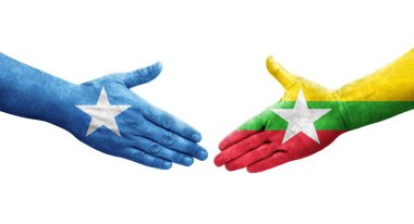 Myanmar ve Somali bayrakları arasındaki el sıkışma ellerinde resmedilmiş şeffaf görüntü.