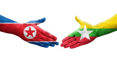 Myanmar ve Kuzey Kore bayrakları arasındaki el sıkışma ellerinde resmedilmiş şeffaf görüntü.
