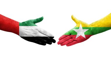Myanmar ve BAE bayrakları arasındaki tokalaşma elleri boyalı, izole şeffaf görüntü.