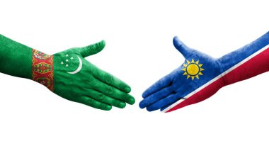 Ellerinde Namibya ve Türkmenistan bayrakları arasında el sıkışma, izole şeffaf görüntü.