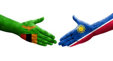 Ellerinde Namibya ve Zambiya bayrakları arasında el sıkışma, izole saydam görüntü.