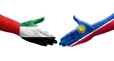 Ellerinde Namibya ve BAE bayrakları arasında el sıkışma, izole şeffaf görüntü.