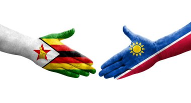 Namibya ve Zimbabwe bayrakları arasındaki el sıkışma ellerinde izole şeffaf görüntü.