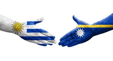 Ellerinde Nauru ve Uruguay bayrakları arasında el sıkışma, izole şeffaf görüntü.