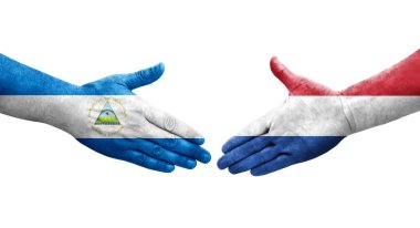 Hollanda ve Nikaragua bayrakları arasında el sıkışma, izole şeffaf görüntü.