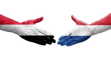 Hollanda ve Yemen bayrakları arasındaki el sıkışma ellerinde resmedilmiş şeffaf görüntü.