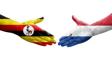 Hollanda ve Uganda bayrakları arasındaki el sıkışma, izole şeffaf görüntü.