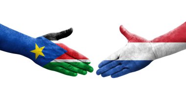 Hollanda ve Güney Sudan bayrakları arasındaki el sıkışma ellerinde resmedilmiş şeffaf görüntü.