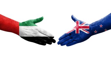 Yeni Zelanda ve BAE bayrakları arasında el sıkışma, izole şeffaf görüntü.