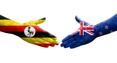 Ellerinde Yeni Zelanda ve Uganda bayrakları arasında el sıkışma, izole şeffaf görüntü.