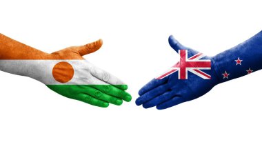 Yeni Zelanda ve Nijer bayrakları arasında el sıkışma, izole şeffaf görüntü.
