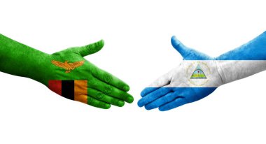 Ellerinde Nikaragua ve Zambiya bayrakları arasında el sıkışma, izole şeffaf görüntü.