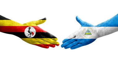 Ellerinde Nikaragua ve Uganda bayrakları arasında el sıkışma, izole şeffaf görüntü.