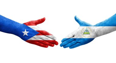 Nikaragua ve Porto Riko bayrakları arasındaki el sıkışma ellerinde izole şeffaf görüntü.