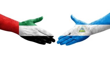 Nikaragua ve BAE bayrakları arasında el sıkışma, izole şeffaf görüntü.