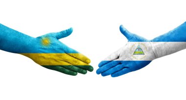 Nikaragua ve Ruanda bayrakları arasındaki el sıkışma ellerinde izole şeffaf görüntü.