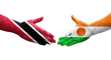 Nijer ve Trinidad Tobago bayrakları arasındaki tokalaşma elleri boyalı, izole şeffaf görüntü.