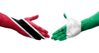 Nijerya ve Trinidad Tobago bayrakları arasındaki el sıkışma ellerinde izole şeffaf görüntü.