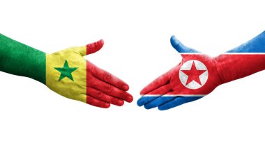Kuzey Kore ve Senegal bayrakları arasındaki el sıkışma..
