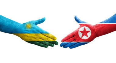 Kuzey Kore ve Ruanda bayrakları arasında el sıkışma, izole şeffaf görüntü.