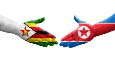Kuzey Kore ve Zimbabwe bayrakları arasında el sıkışma..