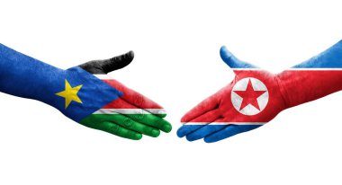 Kuzey Kore ve Güney Sudan bayrakları arasında el sıkışma..