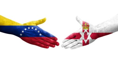 Kuzey İrlanda ve Venezuela bayrakları arasındaki el sıkışma, izole şeffaf görüntü.