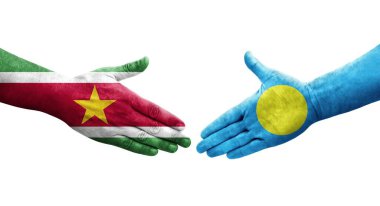 Palau ve Surinam bayrakları arasındaki el sıkışma, izole şeffaf görüntü.