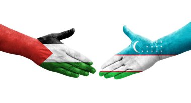 Ellerine resmedilmiş Filistin ve Özbekistan bayrakları arasındaki el sıkışma, izole şeffaf görüntü.