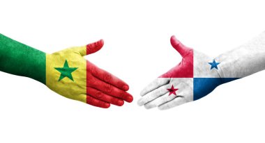 Panama ve Senegal bayrakları arasındaki el sıkışma ellere boyanmış, izole şeffaf görüntü.