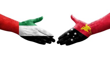 Papua Yeni Gine ve BAE bayrakları arasındaki el sıkışma, izole şeffaf görüntü.