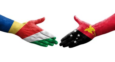 Papua Yeni Gine ile Seyşel bayrakları arasındaki el sıkışma, izole şeffaf görüntü.