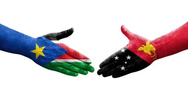 Papua Yeni Gine ile Güney Sudan bayrakları arasındaki el sıkışma, izole şeffaf görüntü.