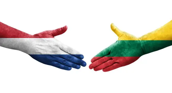 stock image Handshake between Lithuania and Netherlands flags painted on hands, isolated transparent image.