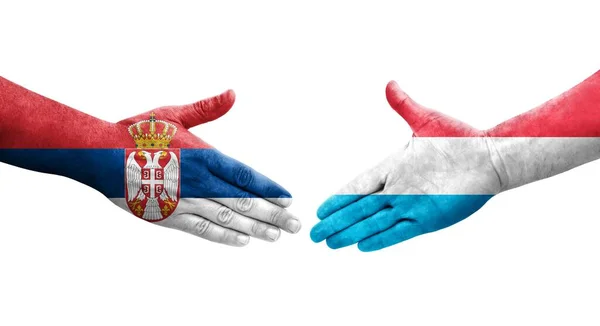 Händedruck Zwischen Luxemburgischen Und Serbischen Flaggen Auf Hände Gemalt Isoliertes — Stockfoto
