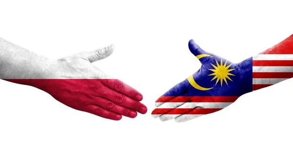 Stock image Handshake between Malaysia and Poland flags painted on hands, isolated transparent image.