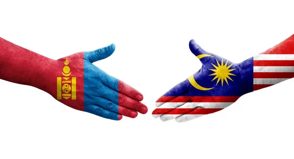 Stock image Handshake between Malaysia and Mongolia flags painted on hands, isolated transparent image.