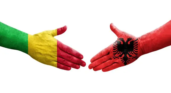 stock image Handshake between Mali and Albania flags painted on hands, isolated transparent image.